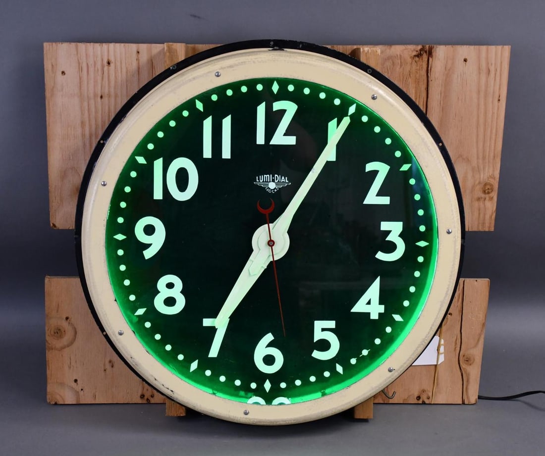 Lumi-Dial Large Neon Clock: rated 8.25, 28"x28"x5", the porcelain face is in excellent condition, neon and clock work, the outside metal can has been repainted.