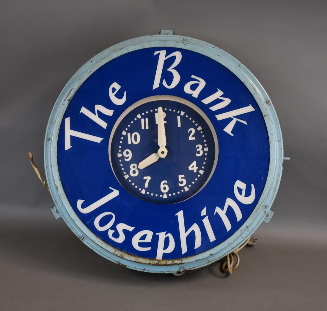 The Bank Josephine Neon Clock: rated 7.5, 26"x26"x7", the clock face and plastic bezel are in good condition, the metal body has rust and wear, clock works and lights up.