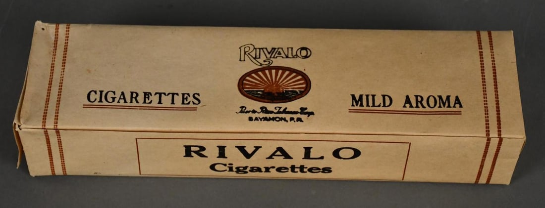 Carton of Rivalo Cigarettes: rated 8, 11"x3"x2", the carton has minor wear, all packs are unopened.