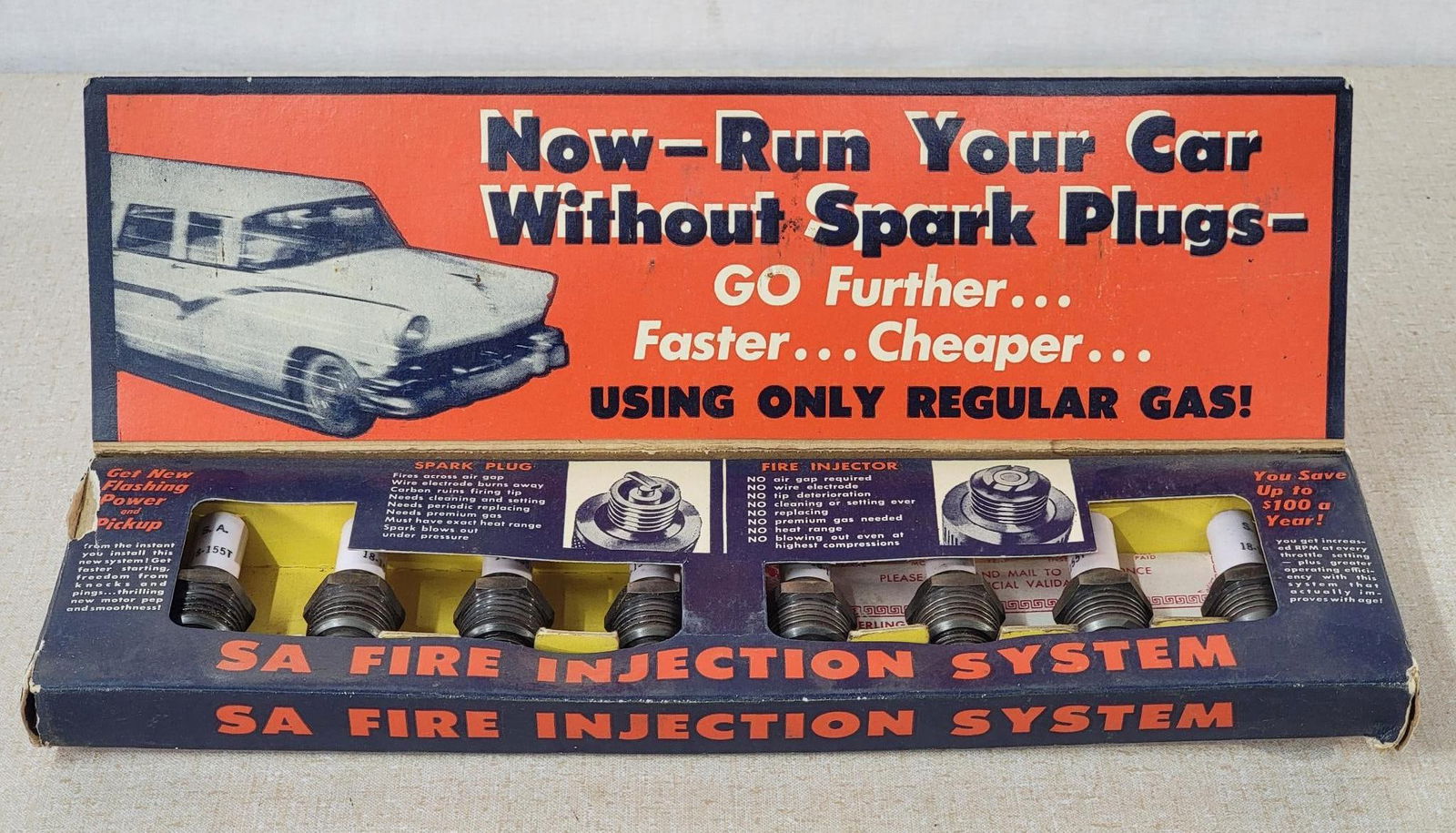 SA Fire Injection System Spark Plugs Set: rated 8, 4"x12"x3.5", the cardboard display has good color, has wear and minor damage, has all of it's spark plugs. 
