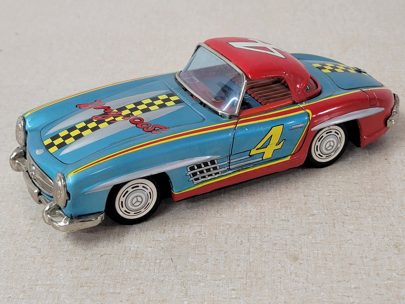 Benz 300 SL #4 Race Car Bandi Japanese Tin Litho Friction Car: rated 9+, 8"L., the tin litho friction has very good color and shine, very light wear, motor works.