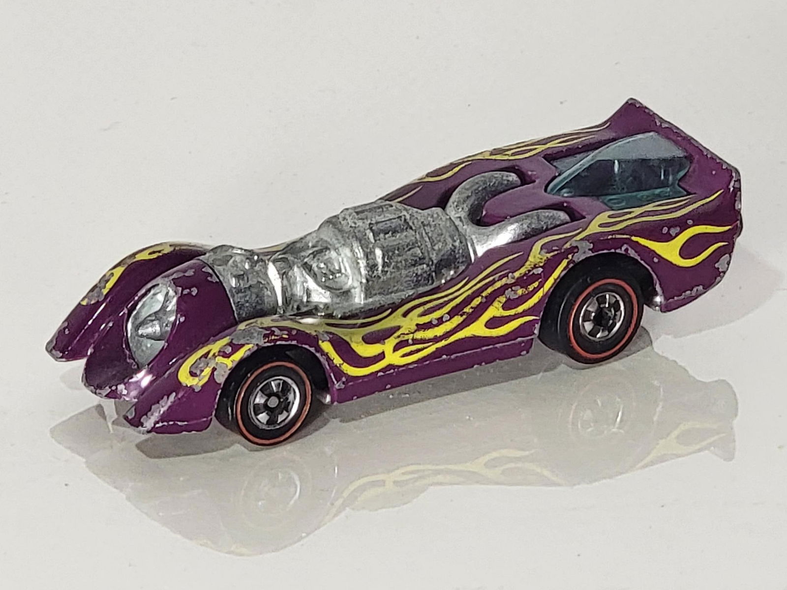 Hot Wheels Red Line Jet Threat: rated 7.5, has good color and shine, has wear and tiny paint chips.