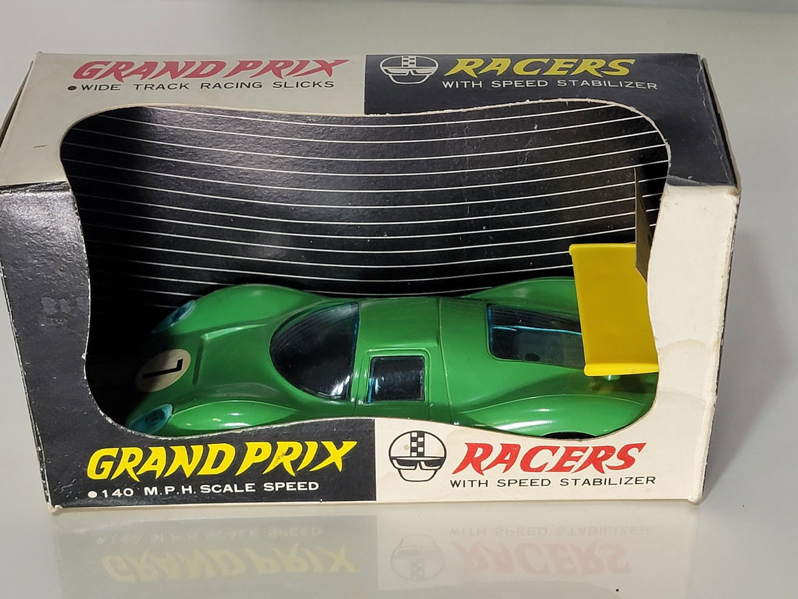 Grand Prix Racers w/Speed Stabilizer w/box Battery Operated: toy rated 8.5, has good color and shine, the back window has a crack, the motor is stuck, box is in good condition, with decals.