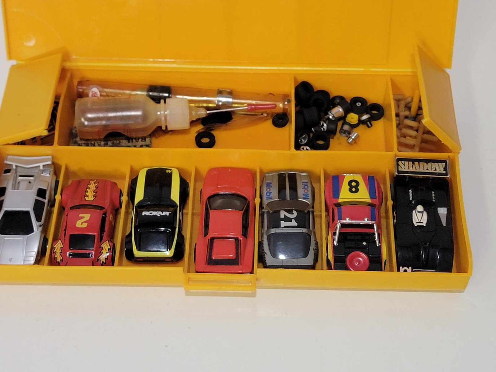 7-HO Scale Slot Cars & Holder: rated 9, all cars are in good condition, comes with plastic holder/parts case.