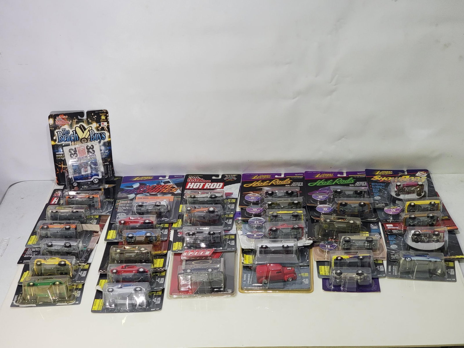 30+ 1/64 Scale Diecast Vehicles Racing Champion, Johnny Lightning and others: rated 8 to 9, 8 in the left hand row has been opened, rest are new in box.