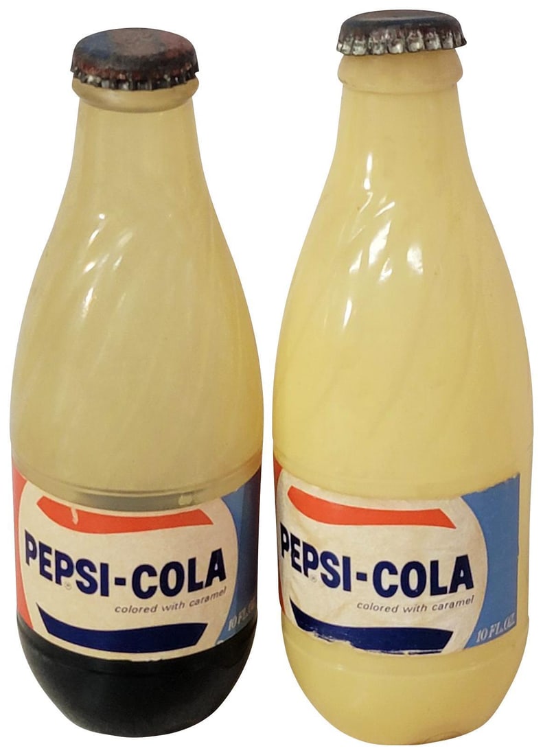 2-Pepsi-Cola 10oz Plastic Long Neck "Vegas Test Bottles": both have good paper labels, one has soda in it, other does not sit right base is off.