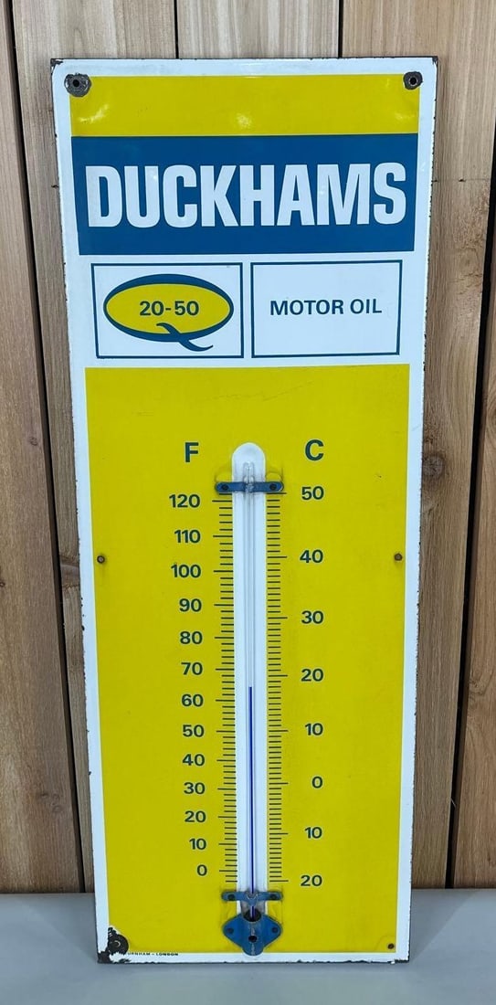 Duckhams Motor Oil 20-50 Porcelain Thermometer (TAC): rated 9, 36"x13", the SSP rolled edge thermometer has good color and gloss, tube is good, field is clean, has chips around the perimeter and mounting holes, marked Durnham. TAC #058986
