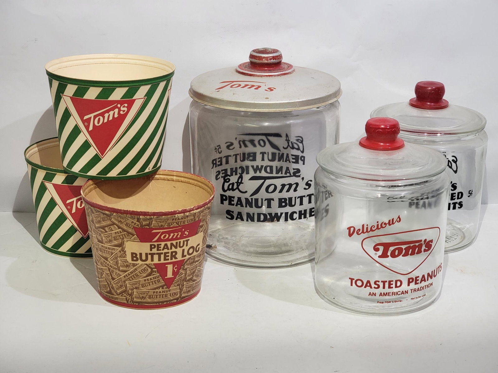 Box Lot of Tom's Point of Sale Jars & More: all in good condition, 12"T. or less in size, comes with three glass jars with lids and three waxed cardboard containers with no lids.