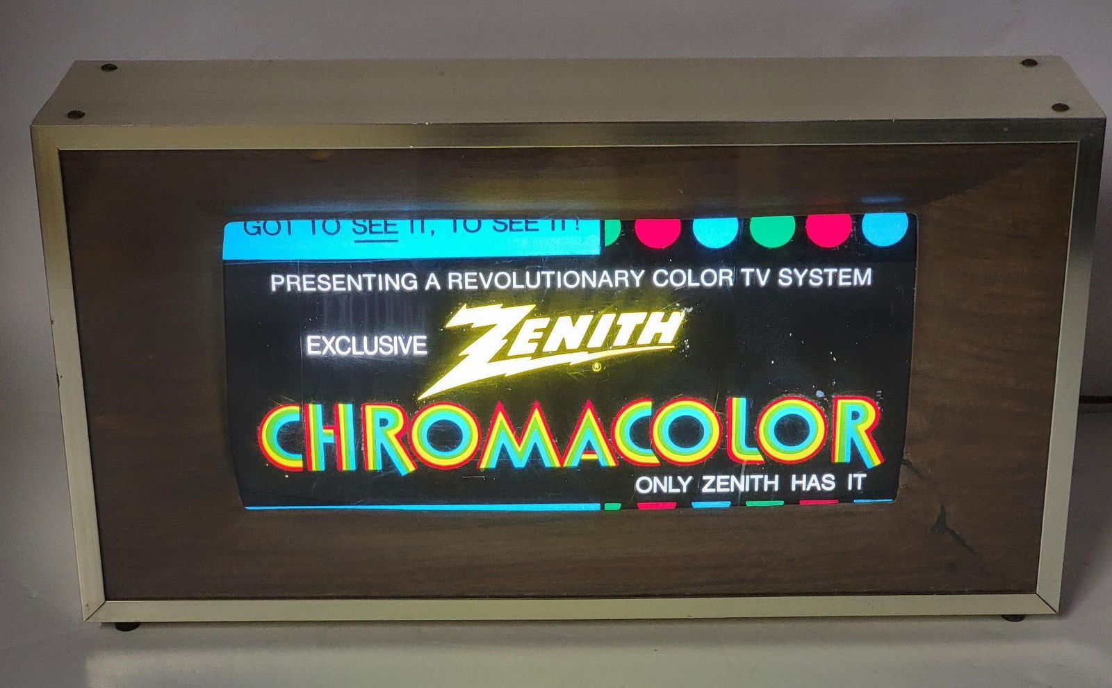 Zenith Chromacolor Lighted Motion Sign: rated 8.5, 11"x20"x4.5", the lighted sign has plastic front with a rolling motion sign that has good color and works well, the plastic wood-grain frame has minor repair, mounted in it's original metal