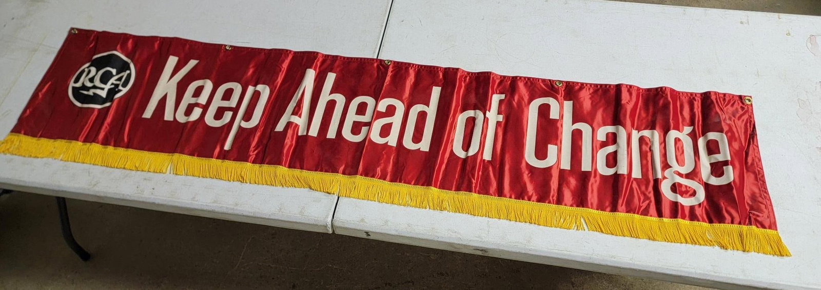 RCA "Keep Ahead of Changer" Banner: rated 8.75, 16"x68", the silk-like banner is in good condition, needs ironed.