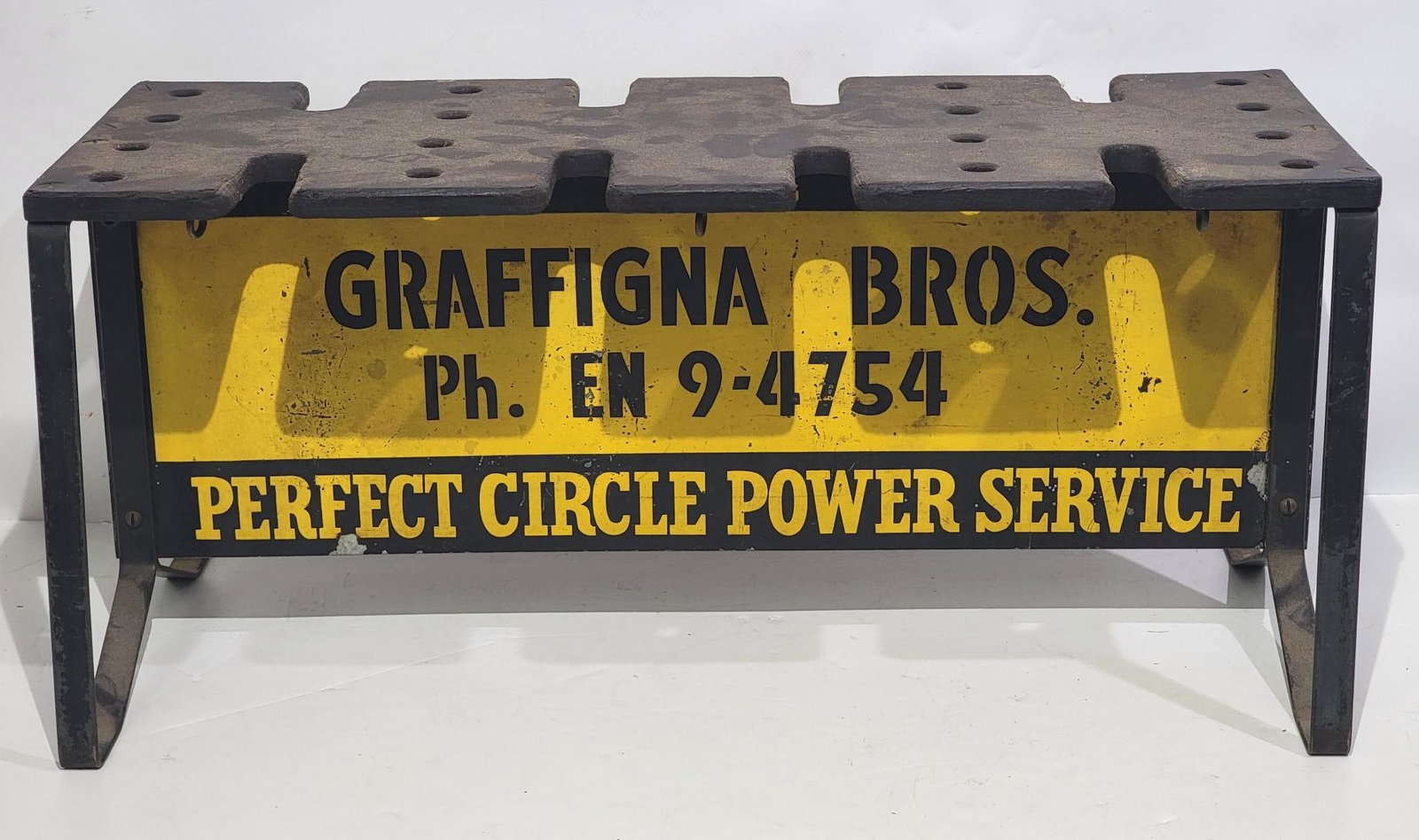 Perfect Circle Power Service Bench/Piston & Valve Holder: rated 7.5, 11"x24"x12", the DST sign has wear and scratches, is mounting on the stand.