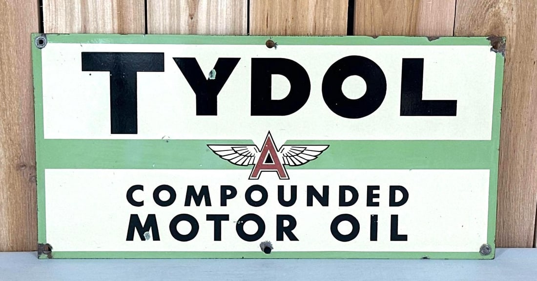 Tydol w/Flying A Logo Compound Motor Oil Porcelain Sign (TAC): rated 8.5, 13"x26", the SSP sign has color and gloss, the red and the green is slightly faded, has small chips around the perimeter. TAC #059284