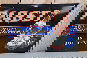 Pabst Blue Ribbon in Bottles w/Image Metal Sign (TAC): rated 8.9, 9.25"x13.25", the SST cardboard backed sign has very good color and shine, has light wear, marked Beach on back. Rarity 6. TAC #059916