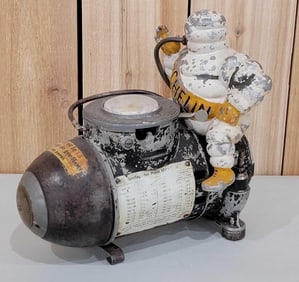 Small Michelin Bibendum Sitting on Air Compressor