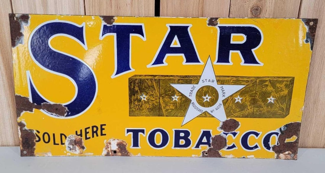 Star Tobacco Sold Here w/Logo Porcelain Sign (TAC): rated 6.9, 12"x24", the SSP sign has good color and gloss, has chips and one extra nail hole in the field, chips around the perimeter. Rarity 1. TAC #060178