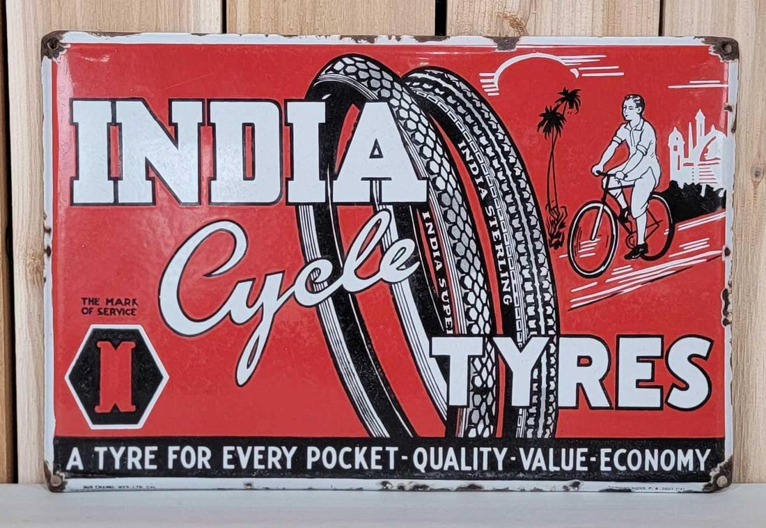 India Cycle Tyres w/Image Porcelain Sign (TAC): rated 8.25, 11.75'x17.75", the SSP rolled edge sign has good color and gloss, has wear in the field and chips around the perimeter, Marked. TAC #060521