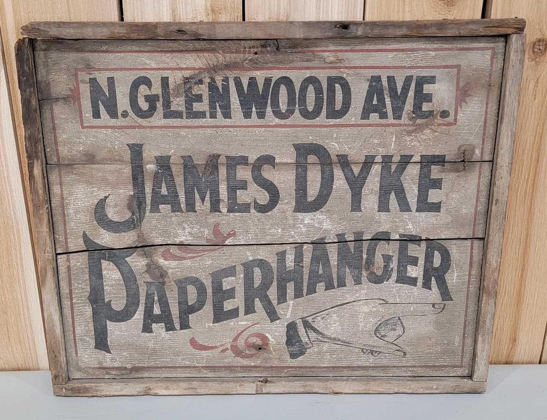 James Dyke Paperhanger w/Pointing Hand Logo Wood Sign: rated 6, 19"x23', the double-sided wood sign has wear and soiling, is loose.