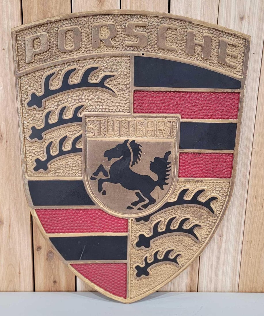 Porsche w/Logo Plastic Shield Sign: rated 8, 36"x27", the embossed plastic sign has good color, has wear, age is unknown on this sign.