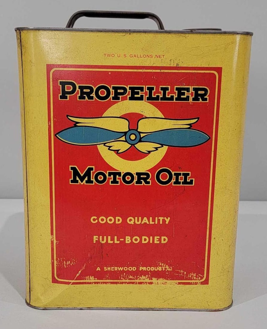 Propeller Motor Oil w/Logo Two-Gallon Rectangle Metal Can: rated 7.75 & 7, This two-gallon rectangle metal can has good color with notable wear and a crease on the bottom edge. Reverse shows more significant wear. Can is empty and missing lid. Rarity 4