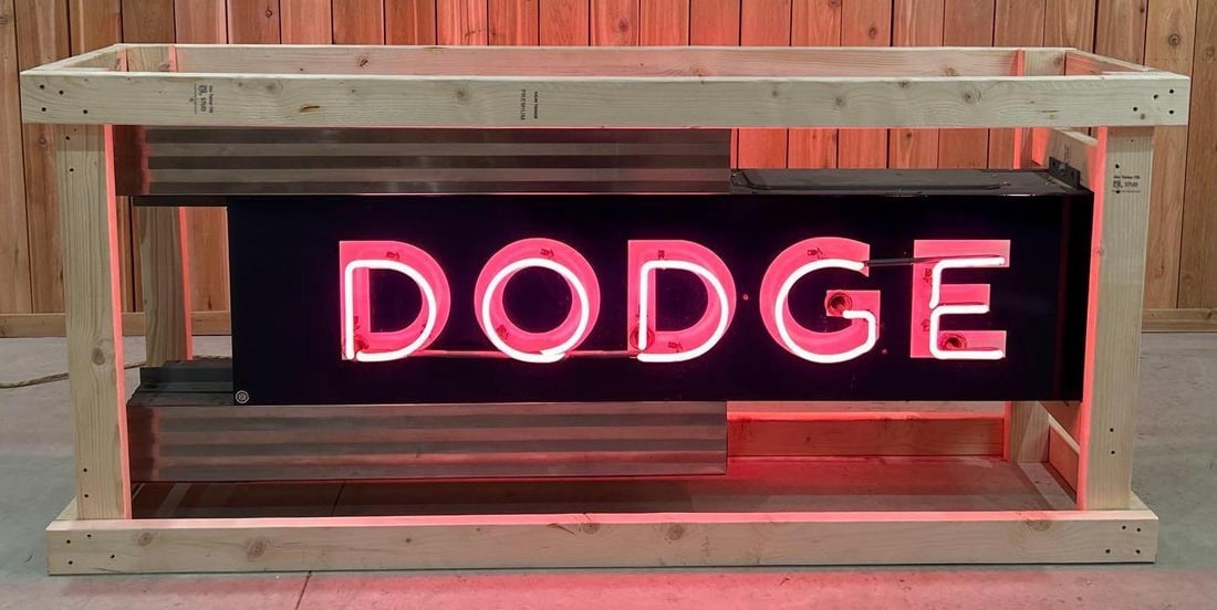 Art Deco Style Dodge Double Sided Porcelain Neon Sign (TAC): rated 9.75, 28"x74"x15" overall, 16"x66" signs. 2-SSP rolled edge neon signs are in excellent condition. The original can has been repainted. Can is flange mounted to the wall. Neo