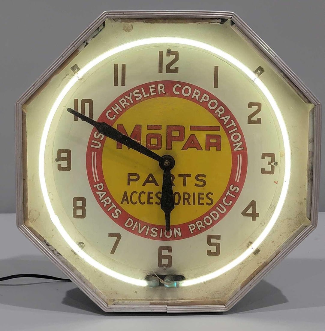 Mopar Neon Octagon Clock: rated 7, 19"x19"x7", This clock keeps time and lights up.Clock has the wrong glass front, is dirty and needs a new cord. If shipped we will not guarantee the neon. 