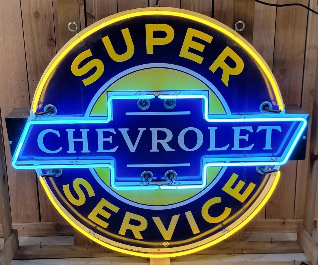 Super Chevrolet Service (black-tip) Neon Porcelain Sign (TAC): rated 8.75, 42"x49", the SSP neon sign with black tips has very good color and gloss with minor staining in the field. Sign has touched up chips around the perimeter. Sign is mounted on a new
