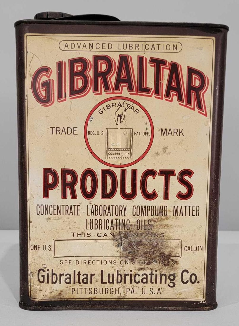 Gibraltar Products w/Logo One-Gallon Flat Metal Can: rated 7,75 & 7.25. The one-gallon flat metal can has good color. Display side has light soiling, wear and minor dings. Reverse side has heavier wear. Can is empty, has lid and spout. Rarity 7.