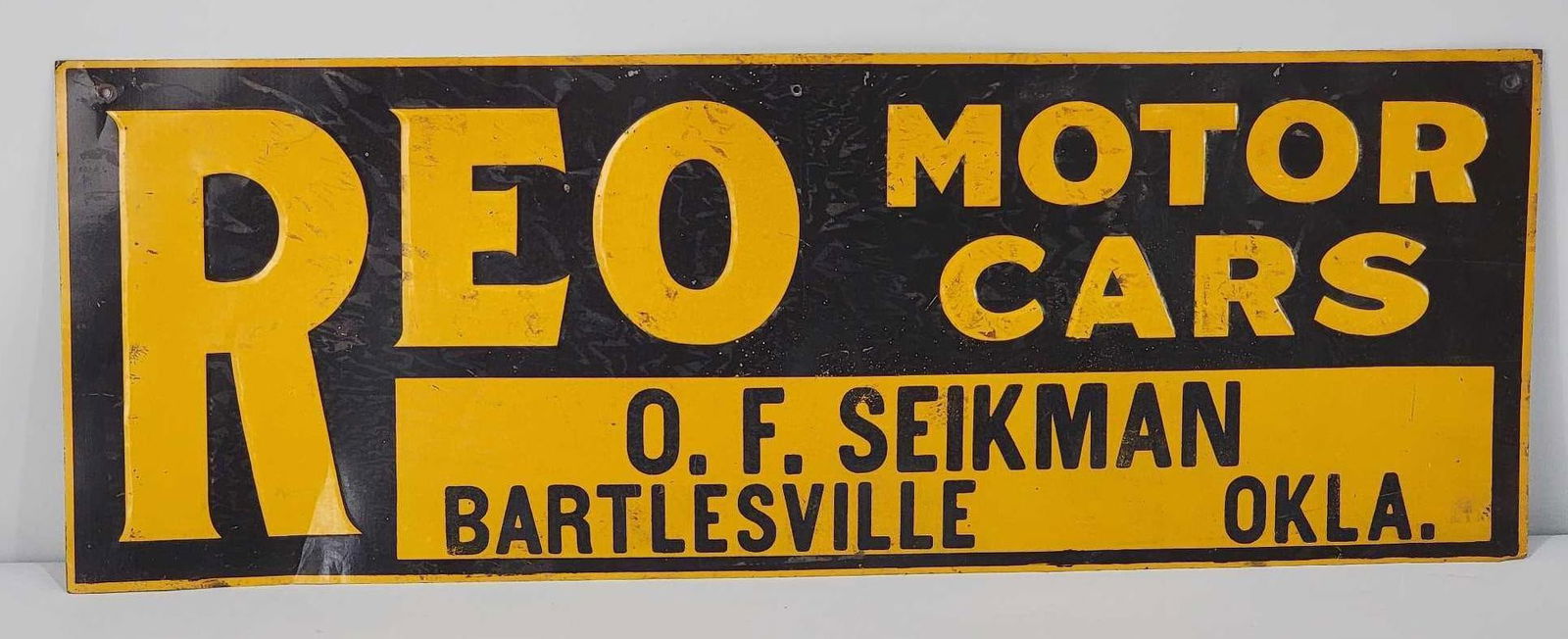 REO Motor Cars Metal Tacker Sign (TAC): rated 7.25, 9.75"x27.75", the SST embossed sign has good color and shine, has paper marks. Rarity 2. TAC #061106
