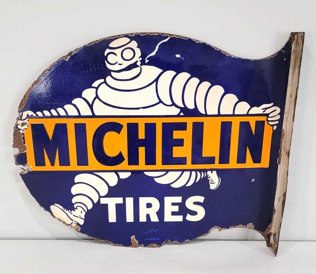 Michelin w/Bibendum Smoking Porcelain Flange Sign (TAC): rated 7.25, 19"x23", the die-cut porcelain flange sign has good color and gloss, a few tiny chips in the field, has chips and metal loss around the perimeter and on the flange. Rarity 6. TAC #060961
