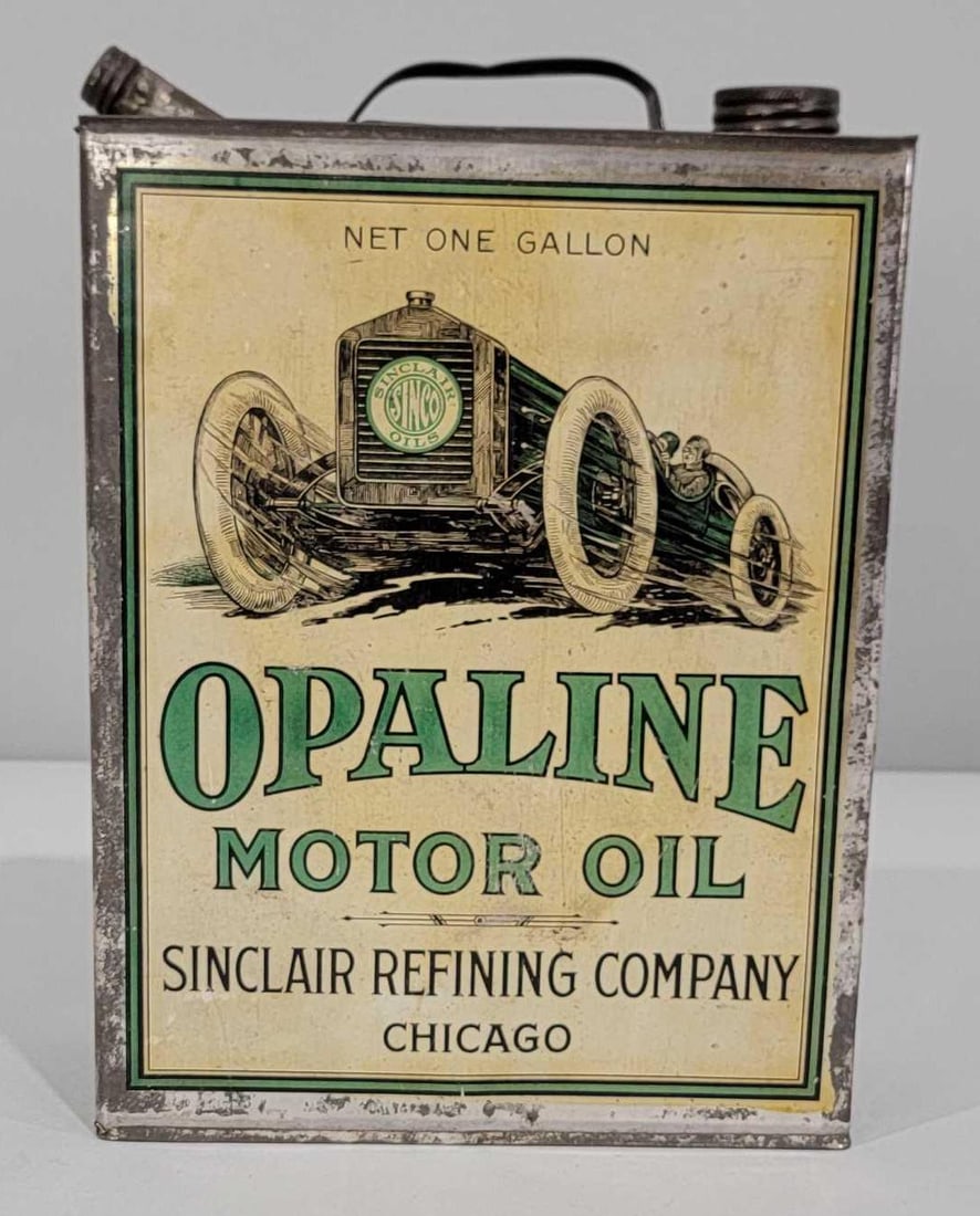 Sinclair Opaline Motor Oil w/Race Car Image One-Gallon Flat Metal Can: rated 8.25 & 8, the one-gallon flat metal can has good color, has light wear and soiling, reverse has more, is empty, has both lids, no spout, is empty. Rarity 7.