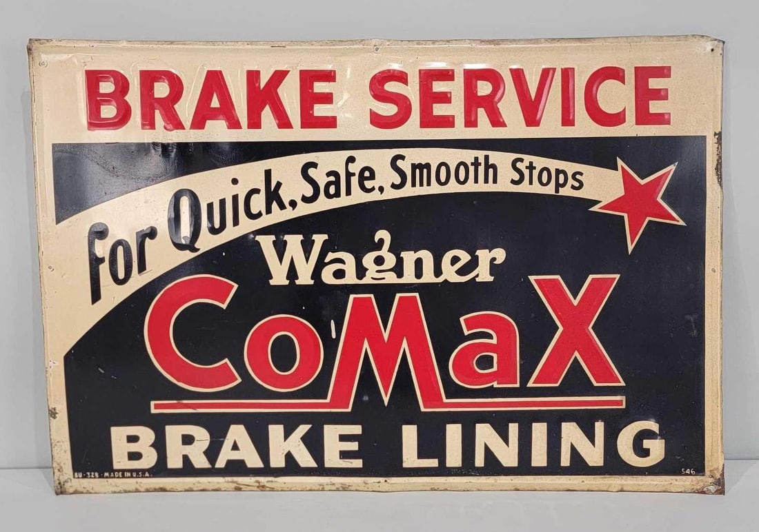 Wagner CoMax Brake Lining Metal Sign (TAC): rated 8, 24"x35.5", the SST embossed sign has good color and shine, field has light wear, has a paint drip, has wear and rust around the perimeter. Rarity 6. TAC #060867