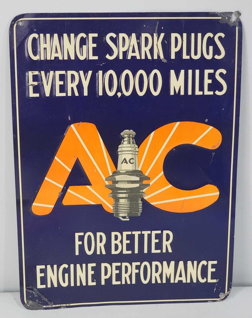 AC "Changes Spark Plugs Every 10,000 Miles" Metal Sign (TAC): rated 7.5, 13.5"x10", the SST embossed sign has good color and shine, has light wear and light paper marks, damage around the perimeter. Rarity 2. TAC #061136