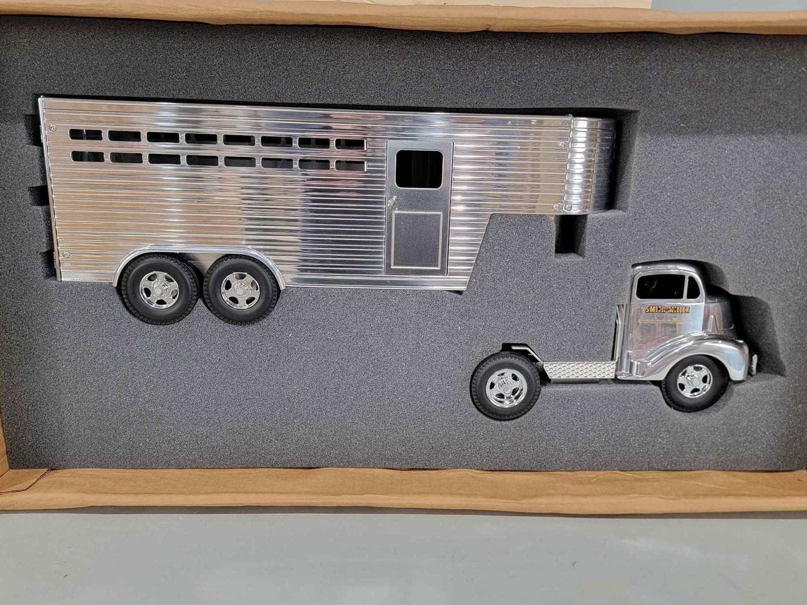 Fred Thompson Smith-Miller GMC Semi w/Horse Trailer NIB: rated 9.5, 38"L. the truck and trailer are new in the box, we opened it for the first time. Box has water damage and staining.