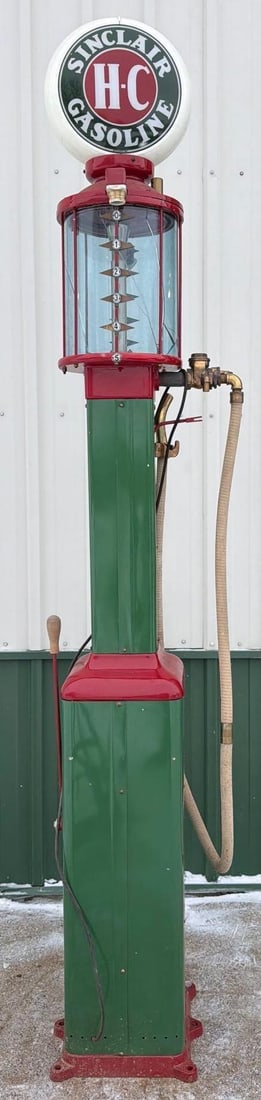 Gilbert & Barker Model #67 Five Gallon Visible Gas Pump: 116"T., the pump has been repainted with green body and red trim, blue glass five gallon cylinder is cracked, comes with white hose and nozzle. This Item must be picked up in Wisconsin