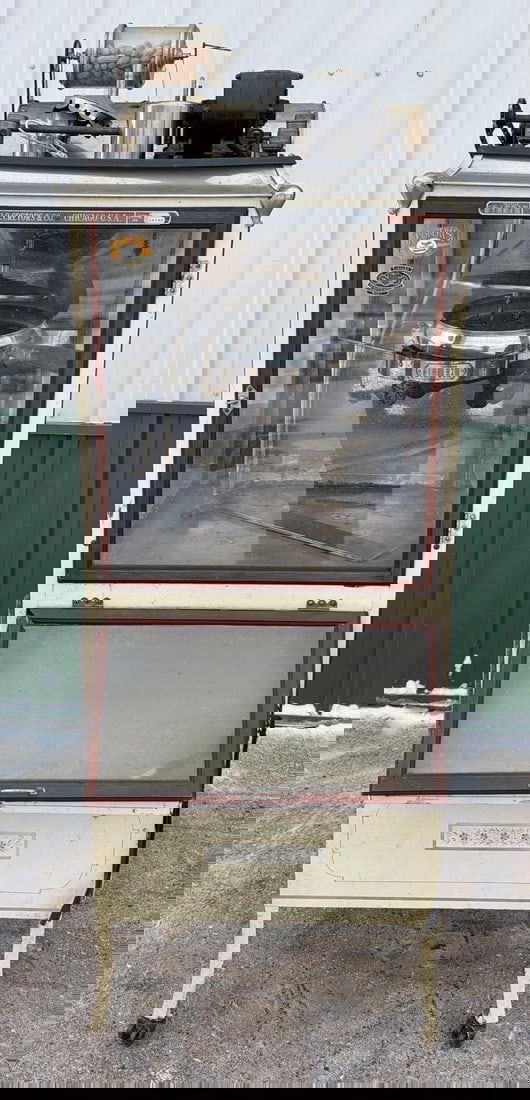 Cretors & Co. Chicago Popcorn Machine w/Peanut Roaster on top: 76"T., the popcorn machine is in original as found condition, looks to be complete but can not guarantee that, does not seem to have and broken parts, glass is good, Engine Number 19788. This Item