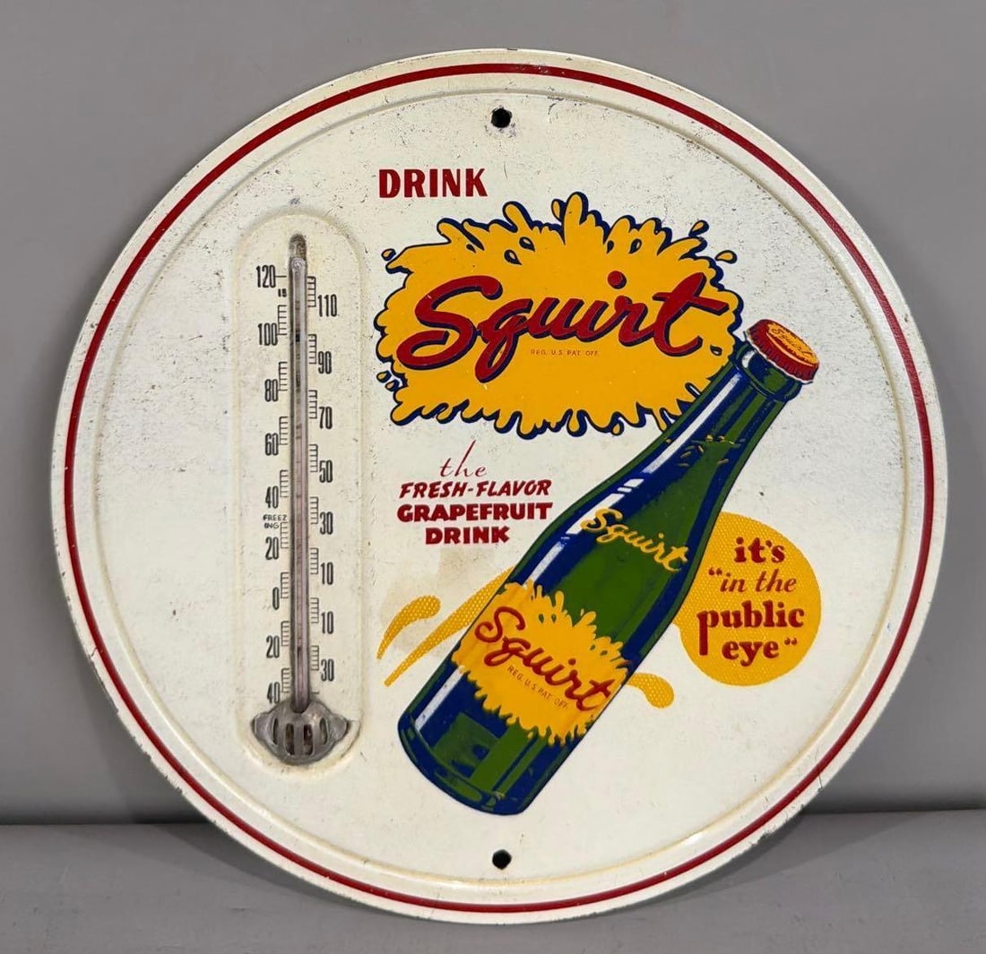 Drink Squirt Thermometer Sign W/ Bottle Graphic: Rated 7.9. 9" dia. This SST thermometer has fair color and shine throughout the field. Sign shows staining on the outer field, as well as, paint loss on the edge. Rarity 3. TAC # 061943