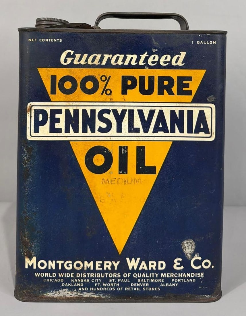 Pennsylvania Oil Montgomery Ward One Gallon Metal Can: rated 7, the one gallon flat metal can, is empty, has wear and scratches, reverse has more.