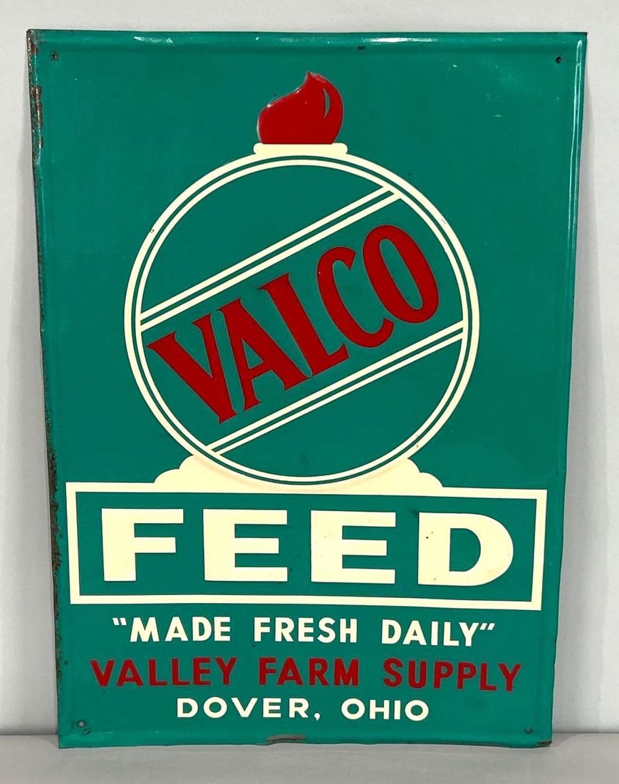 Valco Feeds Self-Framed Embossed Tin Sign: Rated 8.5. 14" x 20". This SST sign has good color and gloss throughout, with minor surface staining and scratching in the field. Outer edge shows areas of paint loss. Marked, "Scioto Sign Co.". Rarit