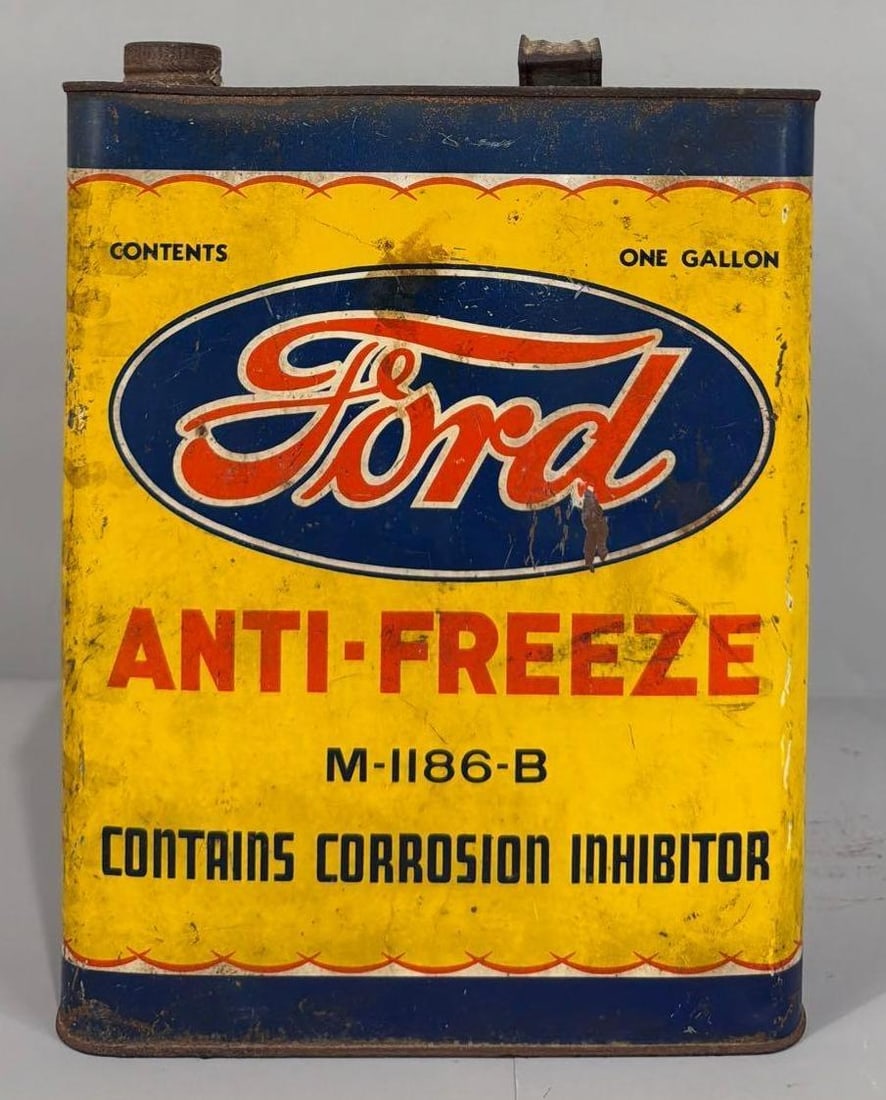 Ford Anti-Freeze One Gallon Flat Metal Can: rated 7.5 & 6.5, the one gallon flat metal can, is empty, has wear and soiling, reverse has more wear.