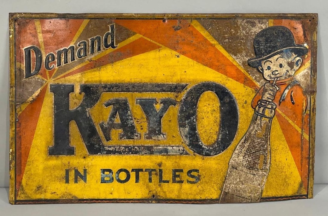 Demand Kayo In Bottles w/Image Metal Sign (TAC): rated 5.5. 17"x27.5", the SST embossed sign has heavy wear, rust spots and extra nail holes. TAC #062785