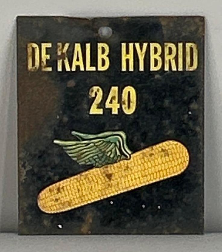 DeKalb Hybrid Metal Tag: Rated 5.5. 2.5" x 3". This DST tag sign has surface staining and paint loss. Rarity 1.