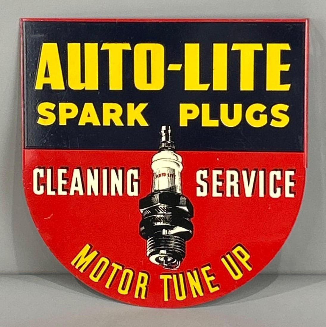 Spectacular Auto-Lite Tin Flange SIgn W/ Early Spark Plug Graphic: Rated 9.5, 9.25. 11.0" x 11.25". This DST flange sign features stellar color and gloss on both sides. Display side presents very light surface scratches, with the reverse side showing slightly more