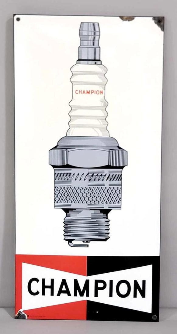 Champion w/Spark Plug Porcelain Sign (TAC): rated 9, 38"x18". This SSP rolled edge sign has very good color and gloss, field is clean. Sign has chips around the perimeter. Marked "Art-France." TAC #061629