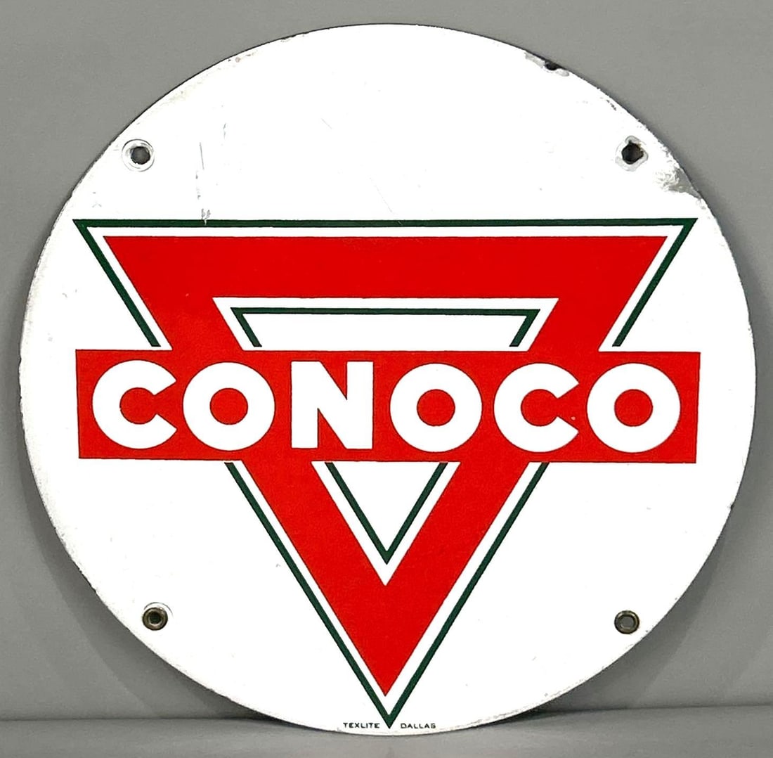 Conoco Porcelain Truck Door Sign: Rated 8.5. 11" dia. This SSP has good color and shine with light surface scratching and staining throughout the field. Outer edge shows minor porcelain loss. Marked, " Texlite Dallas". Rarity 4. TAC