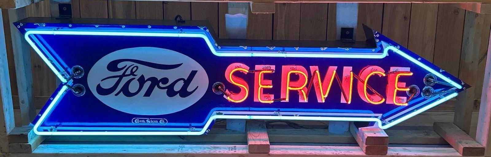 Ford Service Porcelain Neon Arrow W/ Ford Logo: Rated 9.0. 77" x 27" (Crate). This SSP neon porcelain sign has outstanding color and gloss with areas of porcelain loss on the outer edge. Sign is attached to new can. Neon Lights blue and