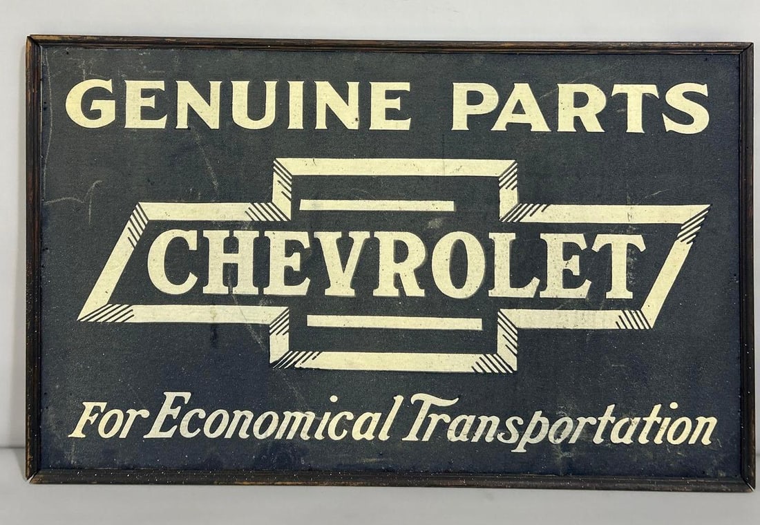 Chevrolet in Bowtie Genuine Parts Metal Smaltz Painted Sign (TAC): rated 8.5, 28.75"x47" This SST Smaltz painted sign has good color. Smaltz paint is in very good condition with only a few large marks. Sign shows extra nail holes around the perimeter. ONE OF THE NICE