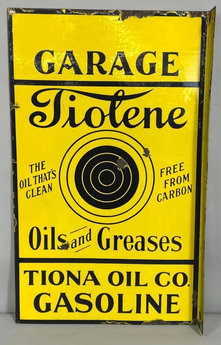 Tiolene Oils and Greases Garage Tiona Oil Co. Porcelain Sign (TAC): rated 8.5, 30"x18", the Porcelain flange sign has good color and gloss with small chips in the field. Sign has chips around the perimeter, 30"x18". TAC #007750