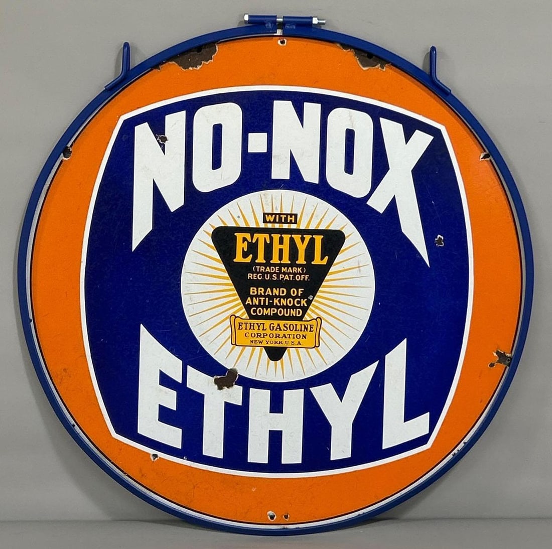 No-Nox w/Ethyl Logo Porcelain Sign (TAC): rated 7.5, 30"D. This DSP sign shows heavy wear and fine scratches. Sign has a few chips and a small drill hole at 12-3-6-9 o'clock. Displayed in a ring. Rarity 4. TAC #061584