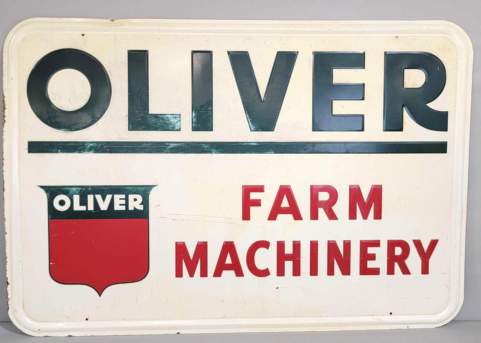Oliver Farm Machinery w/Red Shield Logo on White Metal Reflective Sign (TAC): rated 8, 45"x67.5". The SST self-framed sign has wear and minor soiling in the field. TAC #043147