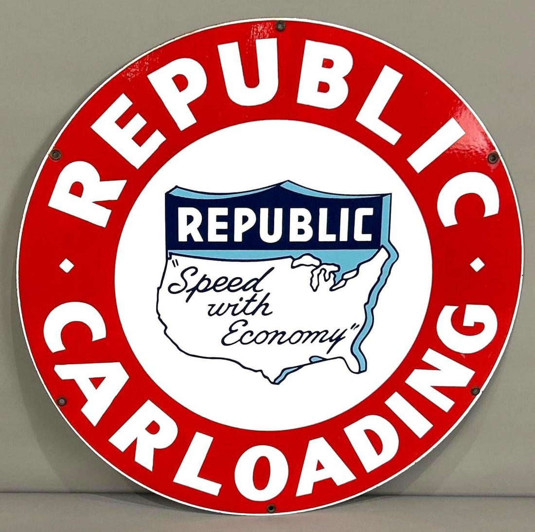 Republic Car Loading Single-Sided Porcelain Sign: (Rated 9). 24" dia. This SSP sign has good color and gloss throughout with minor oxidation running vertically through the red background. Sign shows other extremely minimal surface stains along t